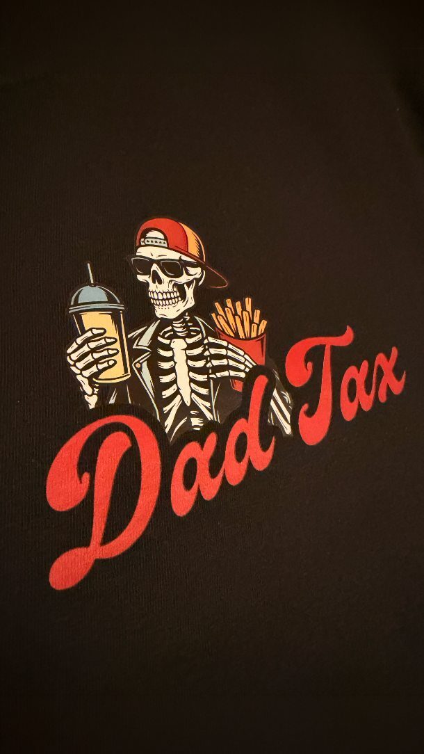 DTF transfer: Dad Tax: the fee nobody gets to opt out of. Bold colors, crisp details and a design that looks SO good pressed on black. This one was made for the dads who some